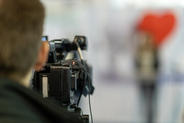 Digital camera in action, recording insightful moments at a media conference