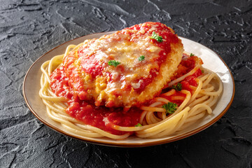 Chicken Parmesan, Italian pasta dish. Breaded chicken breast with cheese and spaghetti with tomato...