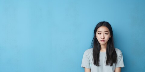 Blue background sad Asian Woman Portrait of young beautiful bad mood expression Woman Isolated on Background depression anxiety fear burn out health issue problem mental 