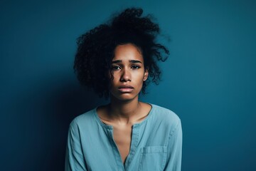Blue background sad black independant powerful Woman realistic person portrait of young beautiful...