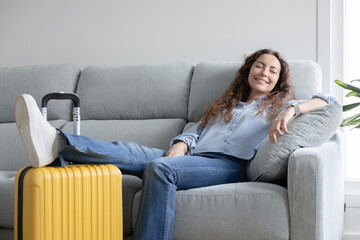 Woman resting in the living room of her house until it's time to go to the airport. Woman resting...