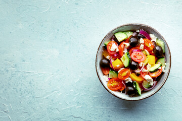 Greek salad. Fresh tomato, cucumber, bell pepper, Feta cheese, onion, and olives. Healthy summer food, overhead flat lay shot with a place for text