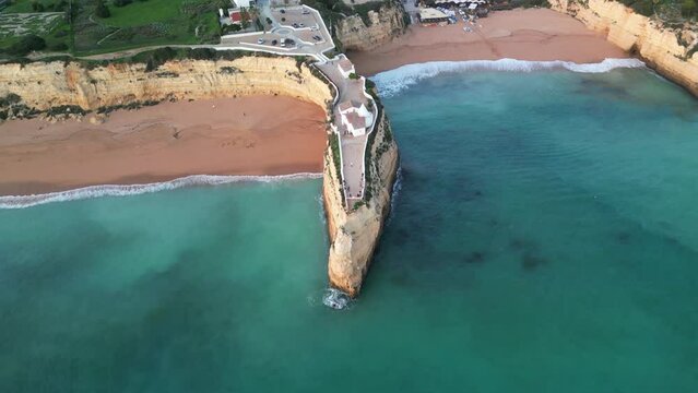 Aerial view of sandy beach and rocky cliff overlooking the Atlantic Ocean, Ermida de Nossa Senhora da Rocha, Porches, Algarve, Portugal.
