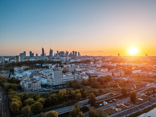 panorama of Warsaw city skyline at sunset, skyscrapers of downtown and green park, aerial top view
