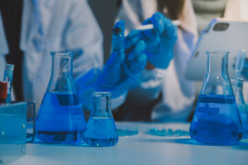 chemist,scientist hand dropping chemical liquid into test tube, science research and development concept