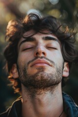 Close up of a man with his eyes closed, suitable for relaxation and meditation concepts