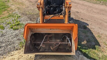 A concrete mixing and dispensing bucket at a construction site. Industrial equipment and labor...