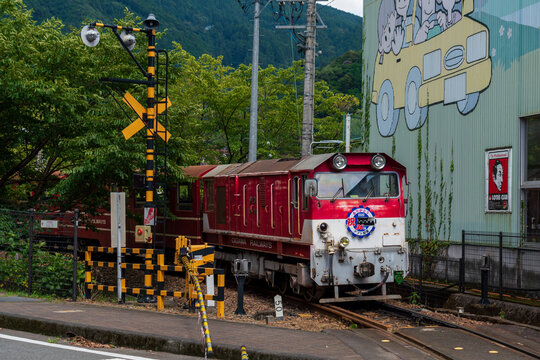 Shizuoka, Japan - April 4 2022: Oigawa railway ABT system trains run through the upstream of Ikawa station and Oku-Oi station at daytime.