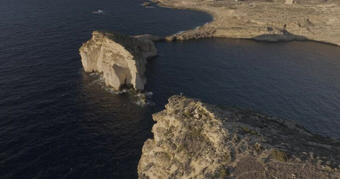Aerial view of rugged Gozo cliffs and Dwejra Bay, Munxar, Malta.
