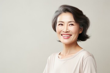 Cream Background Happy Asian Woman Portrait of Beautiful Older Mid Aged Mature Smiling Woman good mood Isolated Anti-aging Skin Care Face Beauty Product Banner 