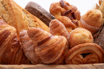 Close-up on bakery - various kinds of breadstuff. Rye bread, wholemeal, baguette, sweet bakery...