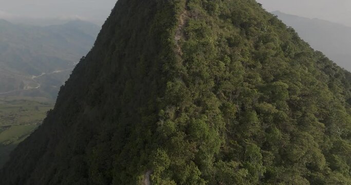 Aerial view of Cerro Tusa with lush forest and remote mountain range, Venecia, Antioquia, Colombia.
