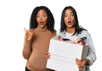 Latin women couple moving, one pregnant  pointing to the side