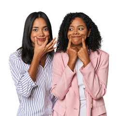 Young Latin businesswomen in studio doubting between two options.