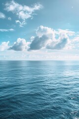 Obraz premium A serene view of a large body of water under a cloudy sky. Ideal for various nature-themed projects