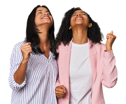 Young Latin businesswomen in studio celebrating a victory, passion and enthusiasm, happy expression.