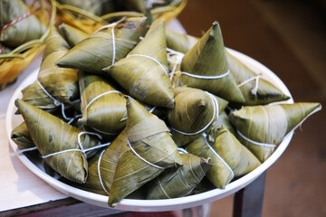many Zongzi (rice dumpling or sticky rice dumpling) on plate. Traditional Chinese food in Dragon...