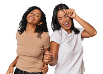 Young Latin friends in studio celebrating a special day, jumps and raise arms with energy.