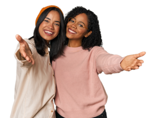 Young Latin friends together in studio showing a welcome expression.