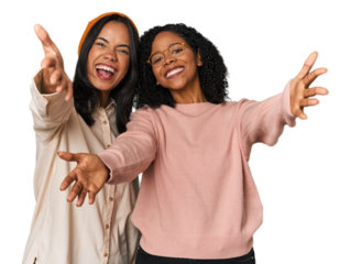 Young Latin friends together in studio feels confident giving a hug to the camera.