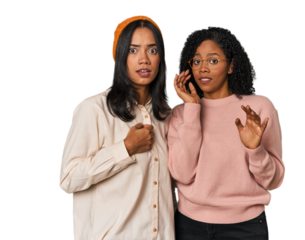 Young Latin friends together in studio being shocked due to an imminent danger