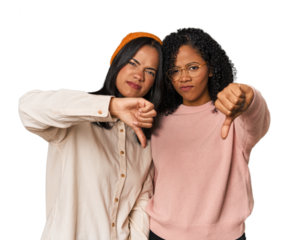 Young Latin friends together in studio showing thumb down and expressing dislike.