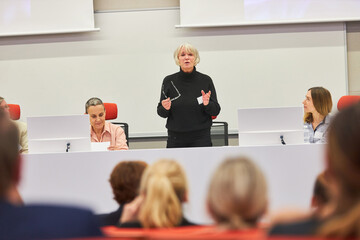 Orator giving speech during business seminar in auditorium