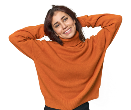 Middle Eastern woman in studio stretching arms, relaxed position.