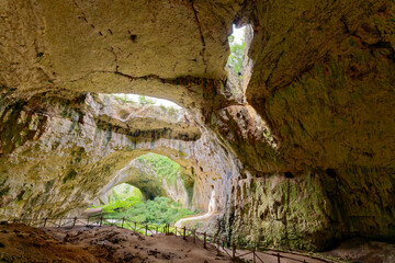 Obraz premium Devetashka Cave in Bulgaria. The Devetashka Cave is a truly spectacular natural phenomenon, imposing in size and unique in its shape.