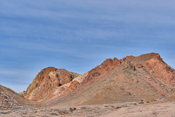 Colored soil of hills over background of blue sky in Charyn Canyon National Park in Kazakhstan.