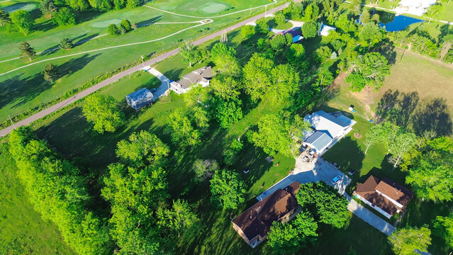 Farm houses on large acreage rural lots lush greenery trees, large storage shed in Mountain Grove Missouri, farmland and ranches in the Midwest peaceful countryside agricultural area, aerial view