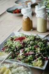 Plate of a salad with herbs on a wooden table