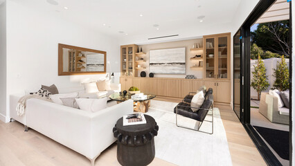 Spacious living room with hardwood floors and white walls