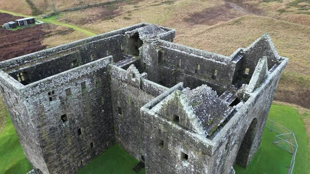 Drone footage of Hermitage Castle in the remote valley of the Hermitage Water, Scotland, UK
