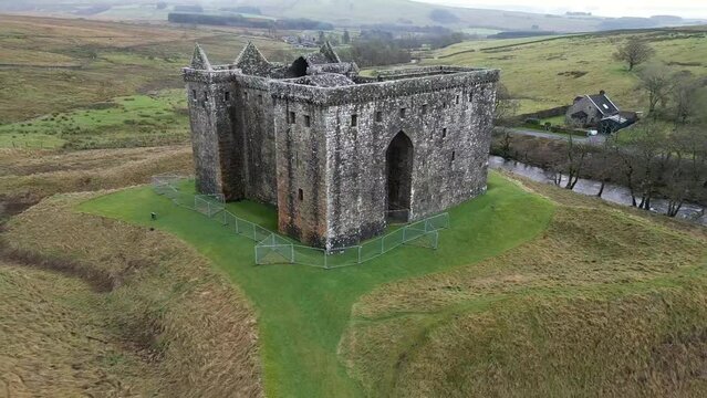 Drone footage of Hermitage Castle in the remote valley of the Hermitage Water, Scotland, UK