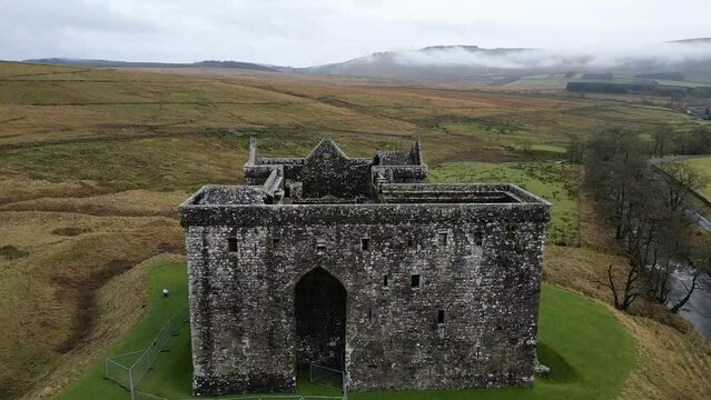 Drone footage of Hermitage Castle in the remote valley of the Hermitage Water, Scotland, UK