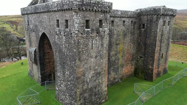 Drone footage of the Hermitage Castle in the remote valley of the Hermitage Water, Scotland, UK