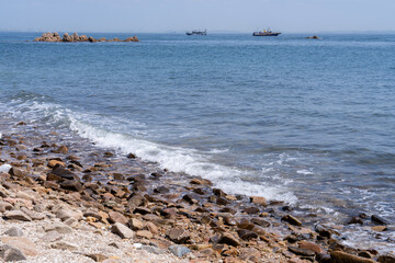 View of the seaside with the surf on the beach