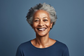 Indigo Background Happy black american independant powerful Woman. Portrait of older mid aged person beautiful