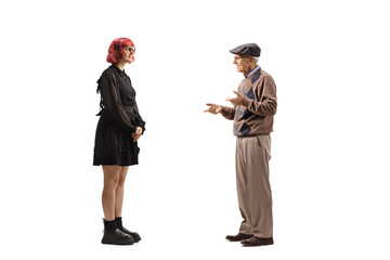 Elderly man talking to a young woman in a black dress