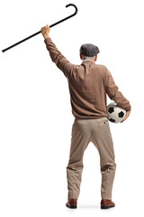 Rear view shot of a happy elderly man holding a football and a walking cane