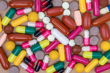 pills and capsules on brown background