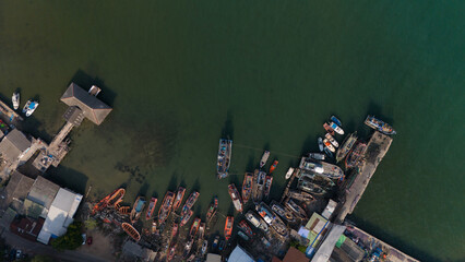 Aerial shot of a tranquil body of water with several boats floating on the surface