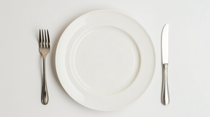 Empty plate fork and knife on white background top view