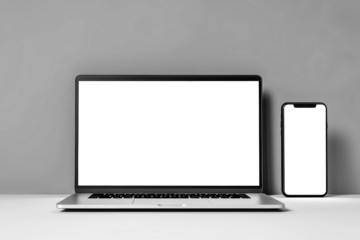 A sleek laptop computer rests on a crisp white desk, ready for productivity and inspiration to flow. Mockup for design. Isolated.