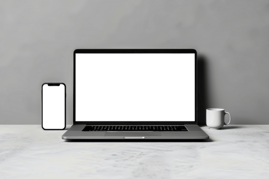 A laptop computer sits on a table next to a cup of coffee. Mockup for design. Isolated.