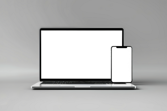 A laptop and a cell phone are placed side by side, showcasing the perfect synergy between technology and communication devices. Mockup for design. Isolated.