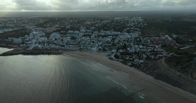 Aerial view of coastal town with beach and ocean at Praia da Luz, Algarve region, Portugal.
