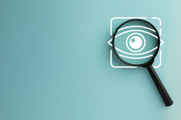 A close-up image of a magnifying glass focusing on an eye icon, representing the meticulous process of analysis, scrutiny, and discovery. Perfect for themes of vision, research, and investigation.