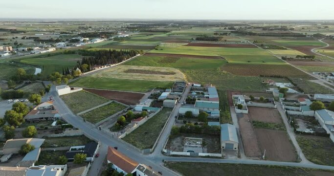 Aerial view of patchwork fields and village homes in San Clemente, Cuenca, Castilla - La Mancha, Spain.
